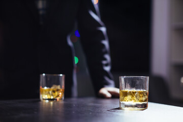 glass of alcohol is left on table after drinking with friends in office after work so that alcohol helps relax mind. Concept of ​​drinking alcohol in moderation and campaigning against drunk driving.