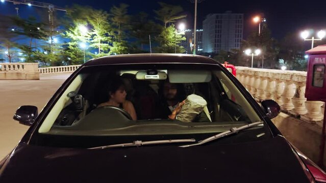 Parked car at night with couple inside