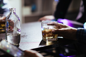 businessman sits and holds glass of liquor in his hand to drink relieve stress after experiencing...