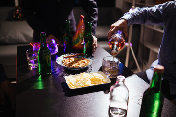 A group of businessmen held brandy glasses together to cheers glasses of brandy after concluding...