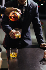 Businessmen and investors drink alcohol together in office after discussing their joint venture plans to conclusion. backdrop of alcoholic celebrations between investors and successful businessmen.