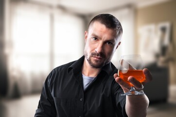Health care alcoholism concept, young man holding glass