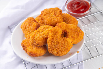 Golden chicken nuggets with ketchup sauce