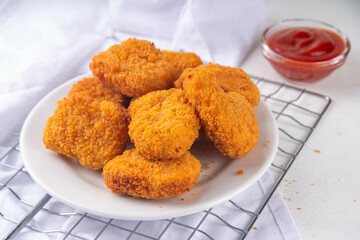 Golden chicken nuggets with ketchup sauce