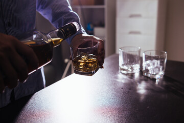 Businessmen and investors drink alcohol together in office after discussing their joint venture plans to conclusion. backdrop of alcoholic celebrations between investors and successful businessmen.
