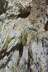 Rock formations and abstract texture on the walls in Muierilor Cave with stalactites and stalagmites