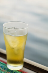Beer, served in glasses, is a popular alcoholic drink around the world and is often used as a celebratory drink during festivals. Beer was served with ice in beer glasses because of the hot weather.