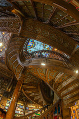 Fototapeta premium Interior of the Livraria Lello e Irmao, known as the Lello Bookshop, oldest in Portugal, dated from 1891, famous for Harry Potter film.Sumptuous interior wood staircase, Porto, Portugal
