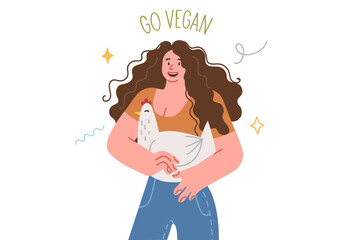 Vegan woman holds chicken with smile and wishes for animals, who need protection