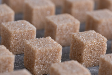 Straight rows of cane sugar cubes. Effect of dynamics.