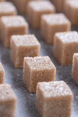 Straight rows of cane sugar cubes. Effect of dynamics.