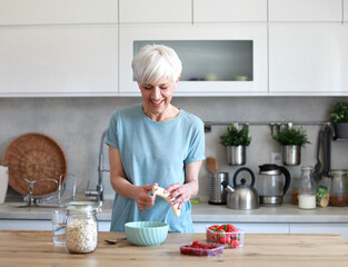 kitchen food woman healthy morning mature breakfast active fitness diet home healthy eating senior...