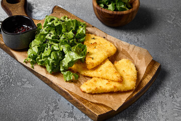 Fried Cheese Bites with Mixed Greens and Berry Sauce on Wooden Board – Gourmet Appetizer