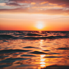Obraz premium Sunset over the ocean: Capture the vibrant colors of a summer sunset reflecting on the water