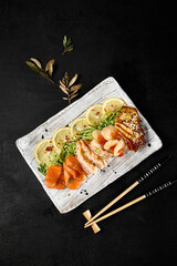 Diverse Sashimi Platter on Dark Background, Featuring Salmon, Shrimp, Scallop, and Eel