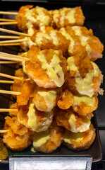 Skewers with tiger prawns shrimps shellfish ready for grill or bbq with mayonnaise