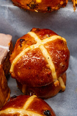 Traditional British Easter food, fresh baked cross buns with raisins or apples