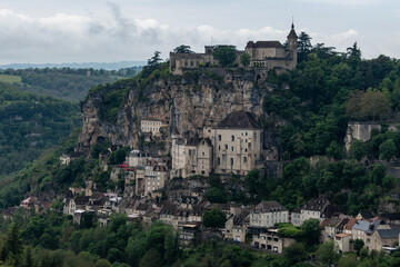 Fototapeta premium Rocamadour medieval village located on pilgrims route in Lot department in southwestern France, attracted visitors for its setting in gorge above tributary of River Dordogne, panoramic view