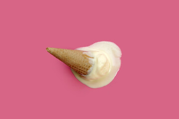 Melting ice cream ball with waffle cone on pink background.