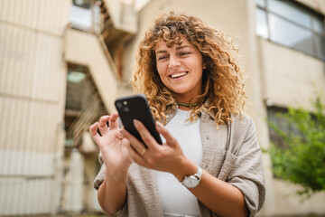 Portrait of adult woman stand in front build use mobile phone