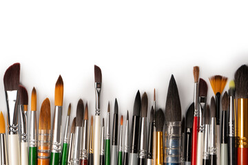 Mix of paint brushes in a row isolated on a white background.  Top view.