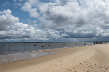 Walking on beach promenade in Arcachon, vacation destination town on Atlantic coast with beatiful parks, villas, streets and sandy beach, France