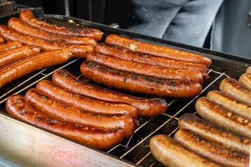 German street food on Portobello road Saturday food market, London, Uk, many BBQ grilled sausages ready to eat in outdoor café