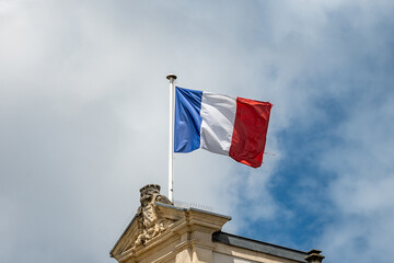 Blue red white french flag on roof of ciry hall in France