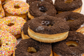 Sweet dessert variety of decorated donuts cakes in confectionery shop