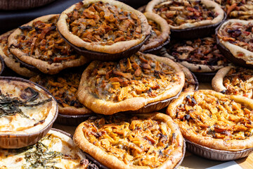 Tasty vegetarian streetfood for lunch in London, various quiche savoury tart swith spinach,...