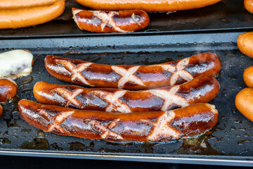 German street food on Portobello road Saturday food market, London, Uk, many BBQ grilled sausages ready to eat in outdoor café