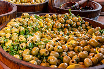 Pickled and marinated olives, artichokes, vegetables on farmers market, tasty tapas
