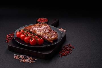 Delicious juicy grilled ribs baked on the grill with salt, spices and herbs