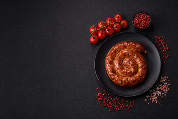 Delicious homemade sausage in the form of a spiral baked on the grill with salt, spices