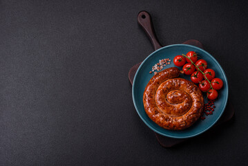 Delicious homemade sausage in the form of a spiral baked on the grill with salt, spices