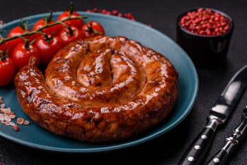 Delicious homemade sausage in the form of a spiral baked on the grill with salt, spices