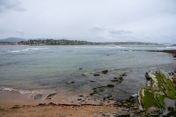 Beach, houses of Saint Jean de Luz on Basque coast, famous resort, known for beautiful architecture, nature and cuisine, South of France, Basque Country