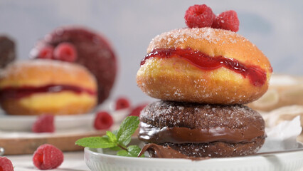 Donuts adorned with raspberries and chocolate