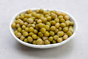 Canned green peas on white background.