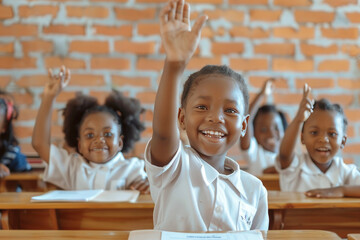 Cheerful young African girl in a school uniform happily raising her hand in a bright classroom