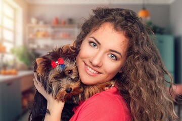 young girl hold hug cute dog at home