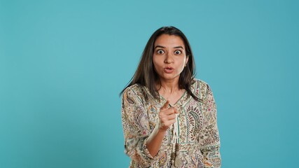Upset indian person fighting with friend, doing scolding gesturing, isolated over studio backdrop....