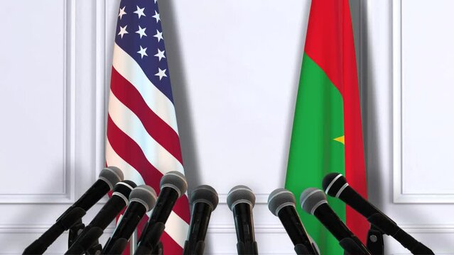 Burkina Faso and USA National Flags with Microphones. Official Press Conference of Countries Government