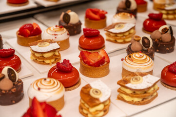 Various sweet cakes meringue, red fruits and berries framboise tartlets with cream