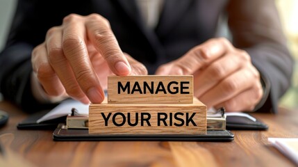 Obraz premium Manage Your Risk. Risk Management. Close-up of hands placing wooden blocks on a desk