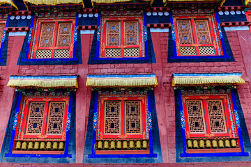 Buddhist temple interior featuring ornate decorations, statues of buddha, and traditional...