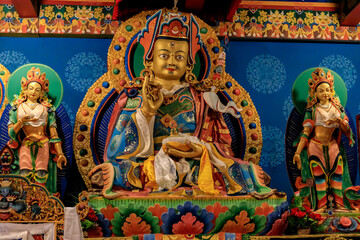 Buddhist temple interior featuring ornate decorations, statues of buddha, and traditional architecture. Serene atmosphere with intricate details, golden accents, religious and cultural artifacts Nepal