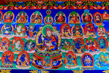 Buddhist temple interior featuring ornate decorations, statues of buddha, and traditional...