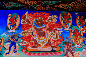 Buddhist temple interior featuring ornate decorations, statues of buddha, and traditional...