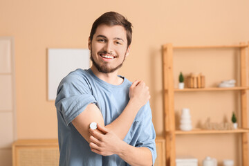 Diabetic young man with glucose sensor at home